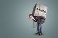 Man carrying a heavy stone with the German word `Miete` on it Royalty Free Stock Photo